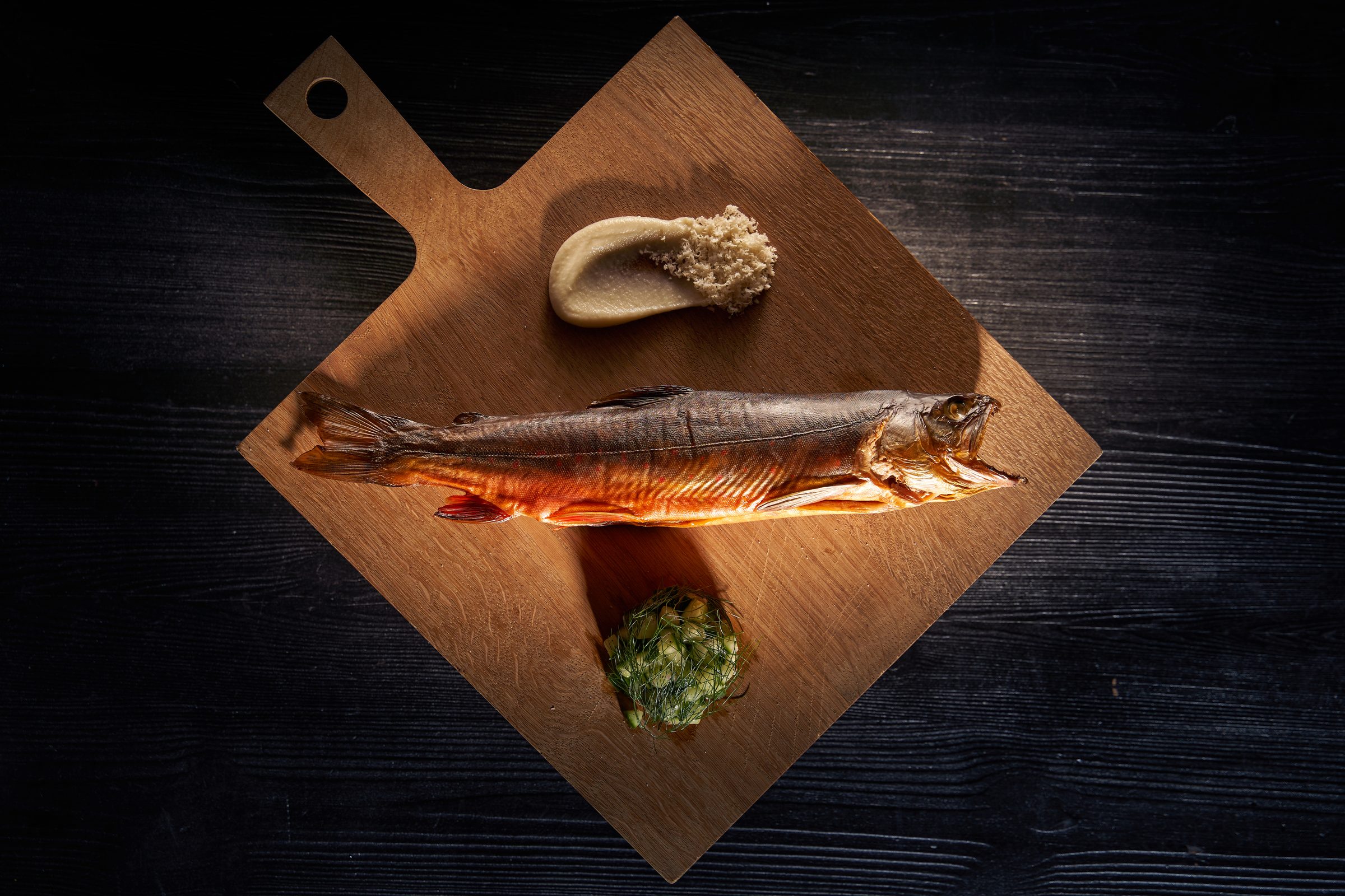 Whole fish served on a wooden board