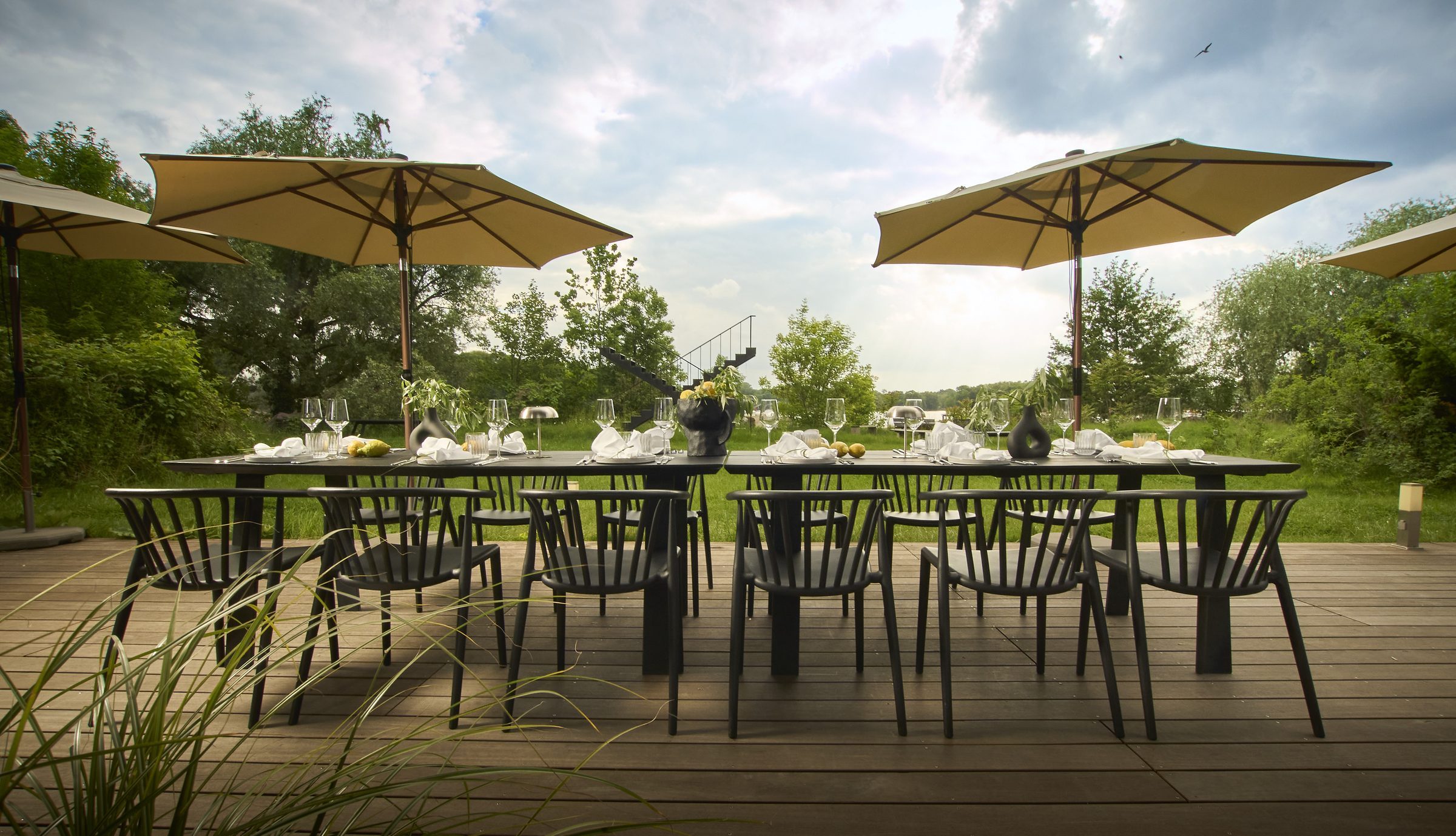 Garden table set under parasols at Studio LA FLOR